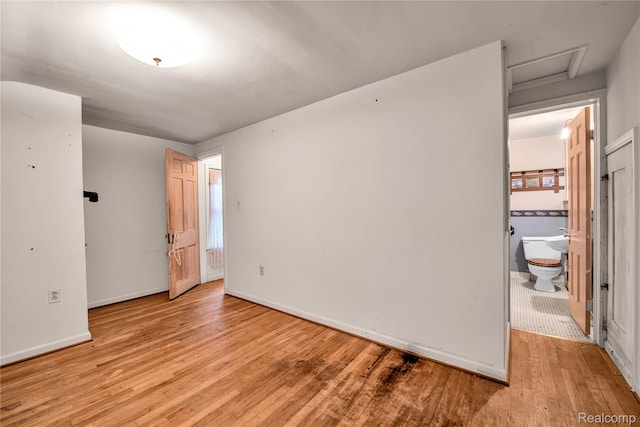 3870 Benstein Rd, Commerce Twp, MI 48382 - unfurnished bedroom with attic access, light wood-type flooring, and ensuite bathroom