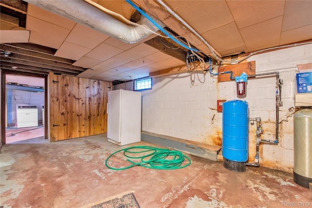 3870 Benstein Rd, Commerce Twp, MI 48382 - below grade area featuring a water pressure tank and freestanding refrigerator