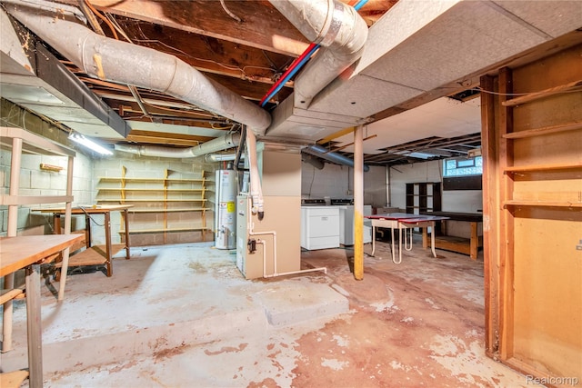 3870 Benstein Rd, Commerce Twp, MI 48382 - basement with gas water heater, washer and clothes dryer, and a workshop area