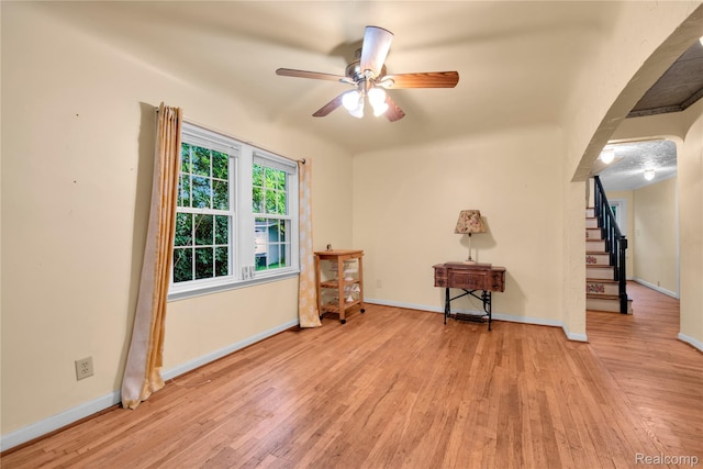 3870 Benstein Rd, Commerce Twp, MI 48382 - unfurnished room featuring light wood-style floors, ceiling fan, and stairway