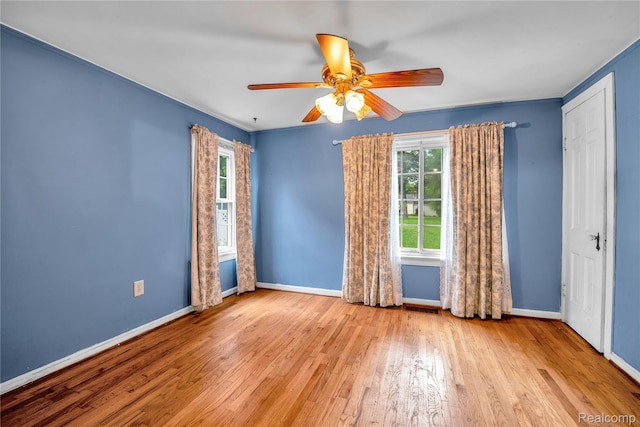 3870 Benstein Rd, Commerce Twp, MI 48382 - spare room featuring plenty of natural light, wood finished floors, and ceiling fan
