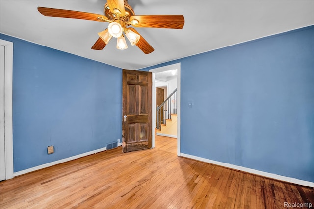 3870 Benstein Rd, Commerce Twp, MI 48382 - unfurnished room featuring wood-type flooring, ceiling fan, and stairs