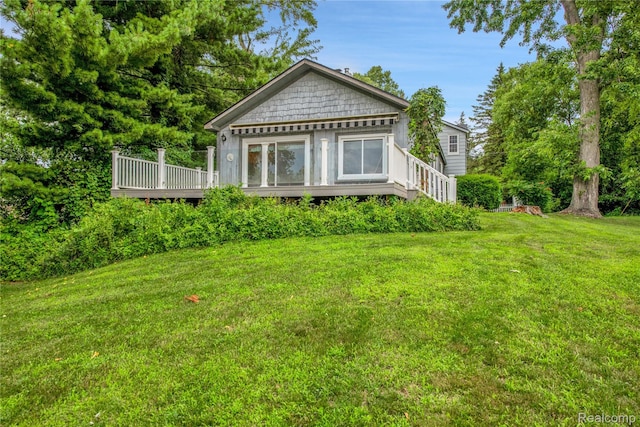 3870 Benstein Rd, Commerce Twp, MI 48382 - view of front of home featuring a wooden deck and a front lawn
