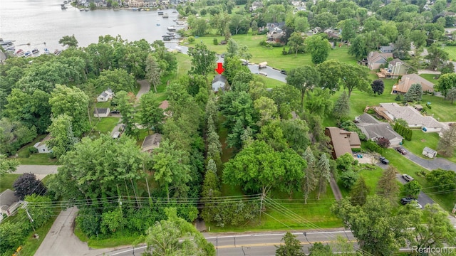 3870 Benstein Rd, Commerce Twp, MI 48382 - aerial perspective of suburban area featuring a large body of water and a tree filled landscape