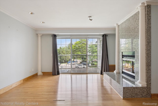 3559 Port Cove Dr Unit 17, Waterford, MI 48328 - unfurnished room featuring decorative columns, wood finished floors, ornamental molding, and a high end fireplace