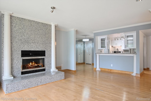 3559 Port Cove Dr Unit 17, Waterford, MI 48328 - unfurnished living room featuring light wood-type flooring, a fireplace, and crown molding