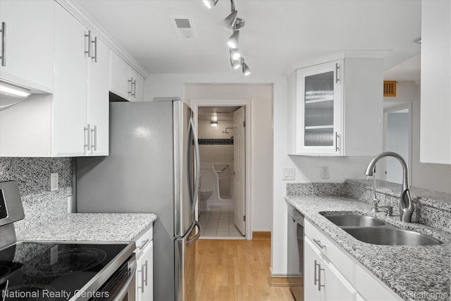 3559 Port Cove Dr Unit 17, Waterford, MI 48328 - kitchen with appliances with stainless steel finishes, white cabinets, light wood finished floors, and glass insert cabinets