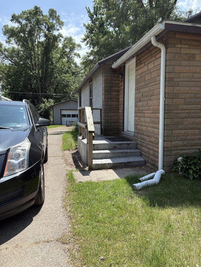 2062 Hatch Ave, Benton Harbor, MI 49022 - view of side of home featuring brick siding, a detached garage, and an outdoor structure