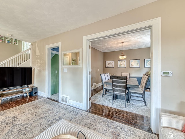 525 Godfroy Ave, Monroe, MI 48162 - dining space with wood finished floors, a textured ceiling, and stairs
