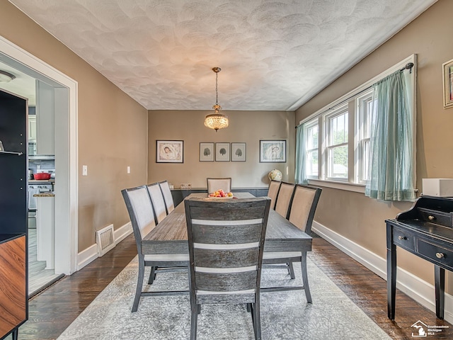 525 Godfroy Ave, Monroe, MI 48162 - dining space featuring dark wood-type flooring and a textured ceiling