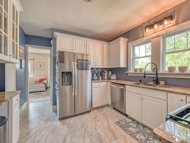525 Godfroy Ave, Monroe, MI 48162 - kitchen with stainless steel appliances, light marble finish flooring, light stone counters, and white cabinets