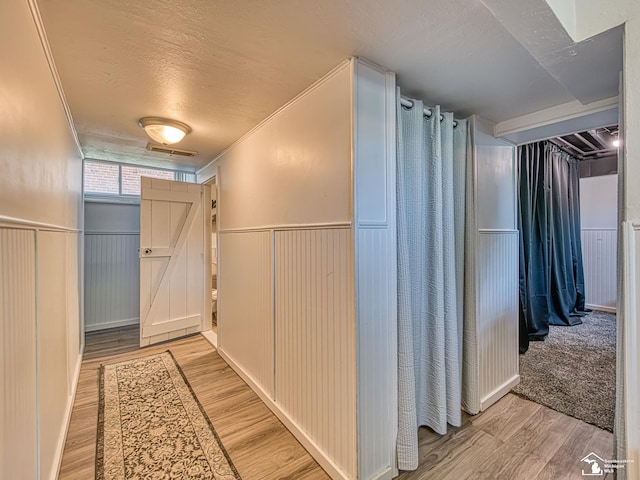 525 Godfroy Ave, Monroe, MI 48162 - hall with wood finished floors, wainscoting, and a textured ceiling