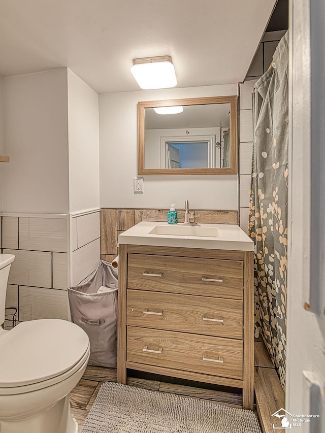 525 Godfroy Ave, Monroe, MI 48162 - full bathroom with vanity, tile walls, and a wainscoted wall