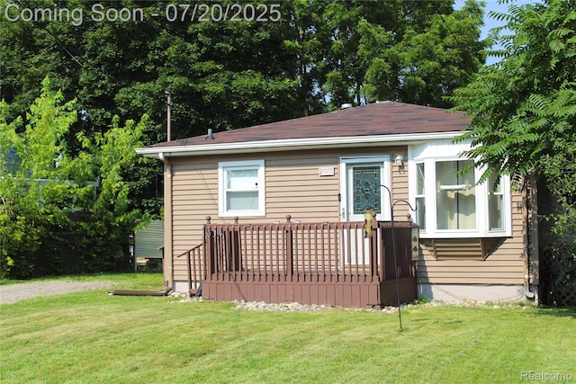 1030 Meida St, Flint, MI 48532 - view of front of house with a front yard and a wooden deck