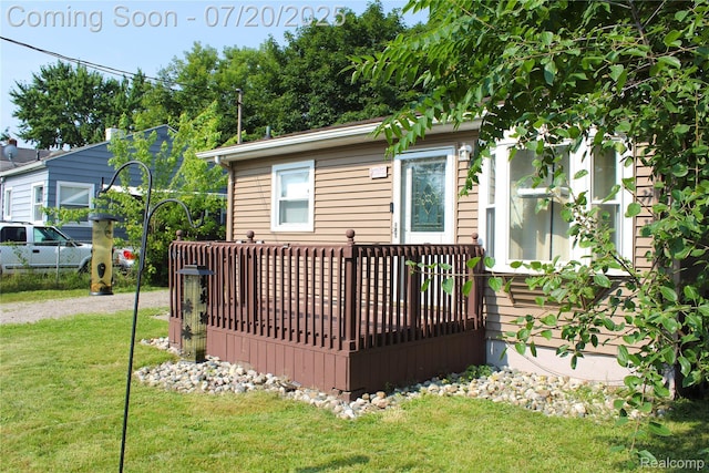 1030 Meida St, Flint, MI 48532 - rear view of house with a deck and a lawn