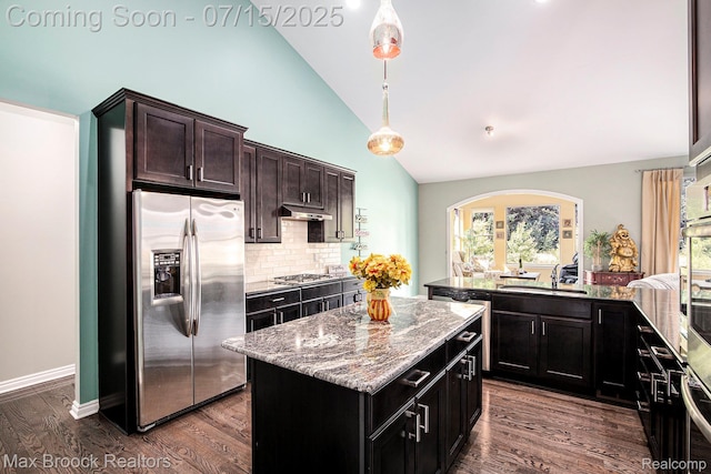 23395 Stoneleigh Ct, South Lyon, MI 48178 - kitchen featuring stainless steel appliances, a center island, light stone countertops, dark wood-style floors, and tasteful backsplash