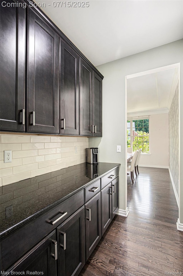 23395 Stoneleigh Ct, South Lyon, MI 48178 - kitchen with dark wood-type flooring, dark stone counters, tasteful backsplash, and dark brown cabinetry