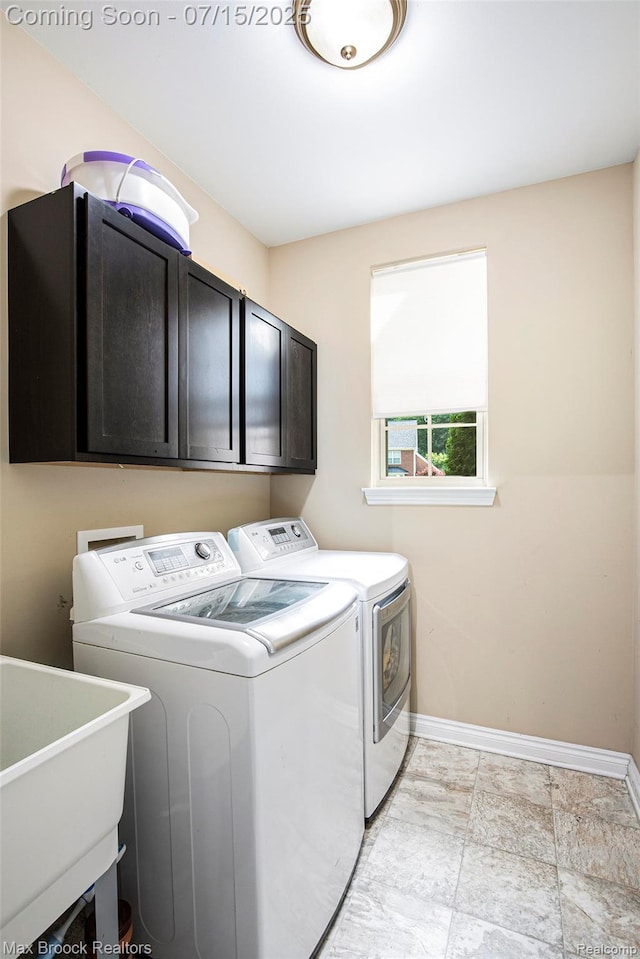 23395 Stoneleigh Ct, South Lyon, MI 48178 - laundry room featuring separate washer and dryer and cabinet space