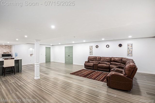 23395 Stoneleigh Ct, South Lyon, MI 48178 - living room with recessed lighting, ornate columns, and light wood-style flooring
