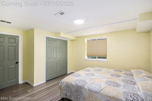 23395 Stoneleigh Ct, South Lyon, MI 48178 - bedroom with dark wood-style flooring and a closet