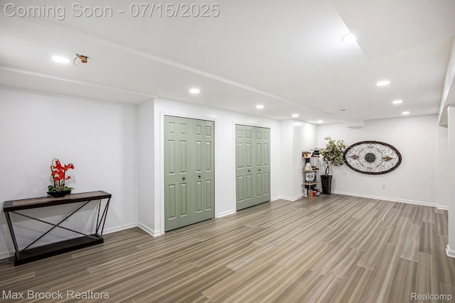 23395 Stoneleigh Ct, South Lyon, MI 48178 - below grade area featuring recessed lighting and wood finished floors