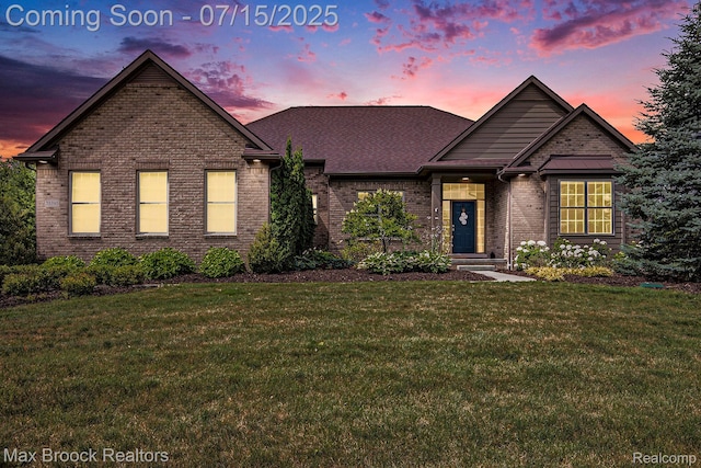 23395 Stoneleigh Ct, South Lyon, MI 48178 - view of front of home featuring a lawn, brick siding, and a shingled roof