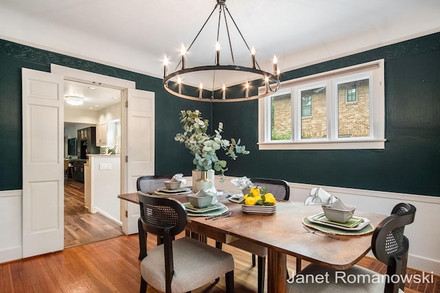 1055 San Lucia Dr SE, Grand Rapids, MI 49506 - dining room featuring a chandelier, wood finished floors, wainscoting, and crown molding