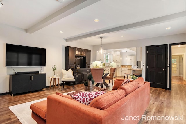 1055 San Lucia Dr SE, Grand Rapids, MI 49506 - living room featuring beam ceiling, light wood-type flooring, and recessed lighting