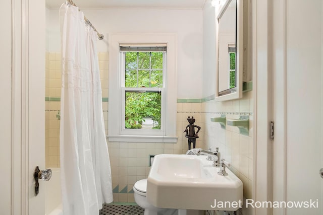 1055 San Lucia Dr SE, Grand Rapids, MI 49506 - bathroom featuring tile walls and shower / tub combo with curtain