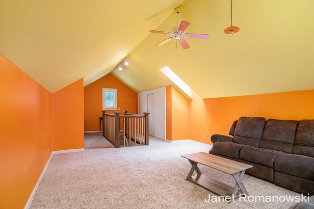 1055 San Lucia Dr SE, Grand Rapids, MI 49506 - carpeted living room featuring vaulted ceiling and a ceiling fan