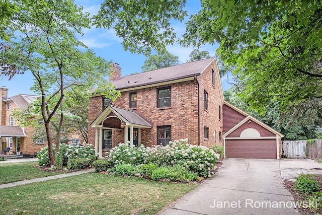 1055 San Lucia Dr SE, Grand Rapids, MI 49506 - view of front of home with driveway, a chimney, a garage, and brick siding