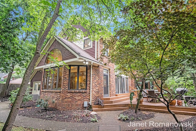 1055 San Lucia Dr SE, Grand Rapids, MI 49506 - view of front facade with brick siding and a wooden deck