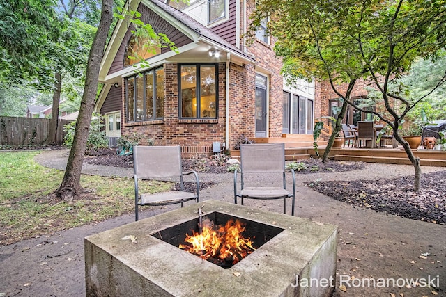 1055 San Lucia Dr SE, Grand Rapids, MI 49506 - view of patio with an outdoor fire pit and a wooden deck