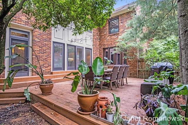 1055 San Lucia Dr SE, Grand Rapids, MI 49506 - wooden deck featuring outdoor dining space and a grill