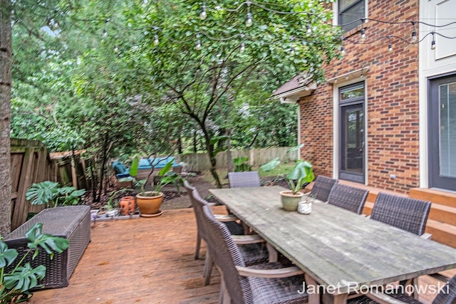 1055 San Lucia Dr SE, Grand Rapids, MI 49506 - wooden deck featuring a fenced backyard and outdoor dining area