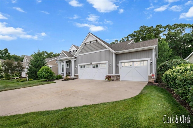 4454 Keena Ct NE Unit 71, Grand Rapids, MI 49525 - craftsman-style home featuring board and batten siding, an attached garage, a front yard, driveway, and stone siding