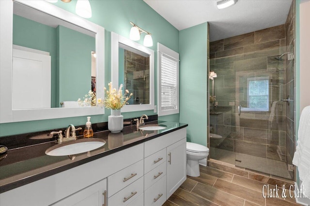 4454 Keena Ct NE Unit 71, Grand Rapids, MI 49525 - full bathroom featuring a stall shower, double vanity, healthy amount of natural light, and wood finish floors