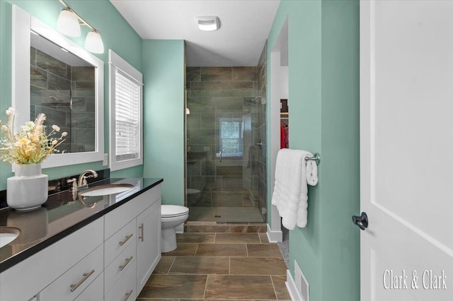 4454 Keena Ct NE Unit 71, Grand Rapids, MI 49525 - bathroom featuring double vanity, a shower stall, and stone finish flooring