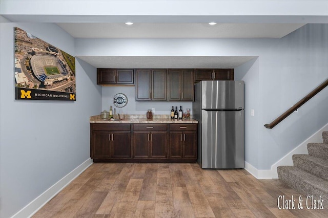 4454 Keena Ct NE Unit 71, Grand Rapids, MI 49525 - kitchen featuring freestanding refrigerator, dark brown cabinets, and light wood-style floors