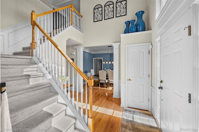 1760 Bedlington Ct, Rochester Hills, MI 48307 - foyer entrance featuring a high ceiling, wood finished floors, ornate columns, and stairway
