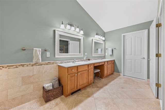 1760 Bedlington Ct, Rochester Hills, MI 48307 - bathroom featuring vaulted ceiling, double vanity, tile patterned floors, and tile walls