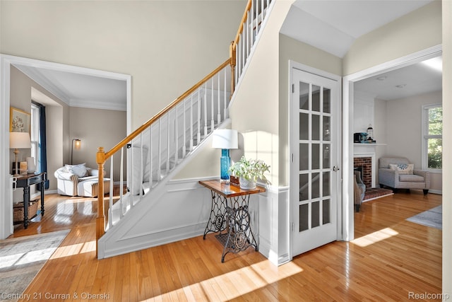 1760 Bedlington Ct, Rochester Hills, MI 48307 - stairway with hardwood / wood-style flooring, ornamental molding, and a fireplace