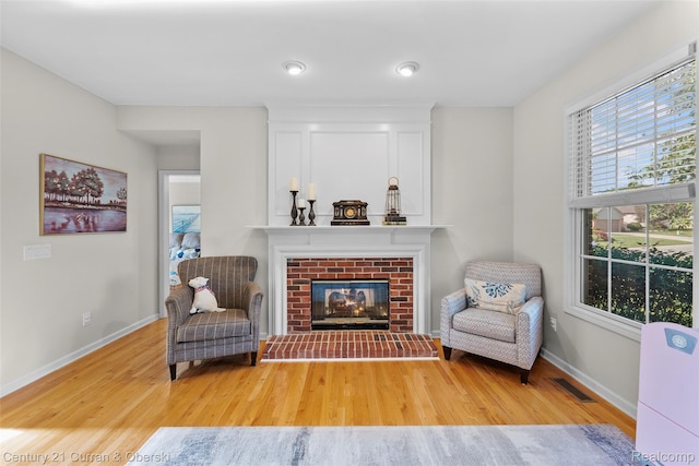 1760 Bedlington Ct, Rochester Hills, MI 48307 - living area with wood finished floors and a brick fireplace