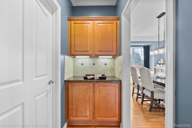 1760 Bedlington Ct, Rochester Hills, MI 48307 - bar with decorative backsplash, wood finished floors, and ornamental molding