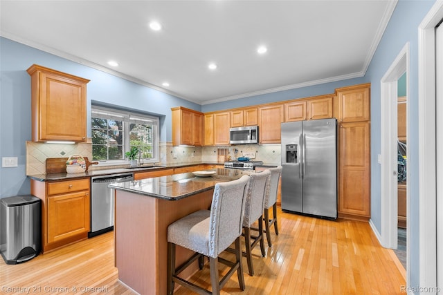 1760 Bedlington Ct, Rochester Hills, MI 48307 - kitchen with appliances with stainless steel finishes, crown molding, a center island, light wood-style floors, and a kitchen bar