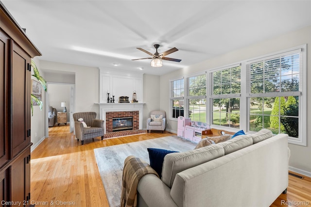1760 Bedlington Ct, Rochester Hills, MI 48307 - living room with a ceiling fan, a fireplace, and light wood finished floors