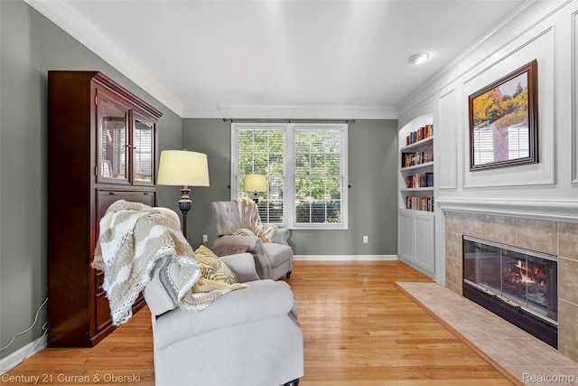 1760 Bedlington Ct, Rochester Hills, MI 48307 - living room featuring crown molding, light wood-style floors, a fireplace, and built in features