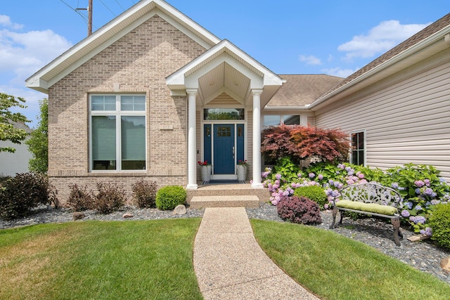 172 Bay Meadows Dr, Holland, MI 49424 - view of exterior entry featuring brick siding and a yard