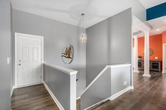 172 Bay Meadows Dr, Holland, MI 49424 - corridor featuring decorative columns, wood finished floors, an upstairs landing, and wine cooler