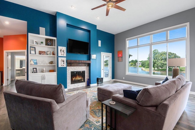 172 Bay Meadows Dr, Holland, MI 49424 - living room with a ceiling fan, a stone fireplace, wood finished floors, recessed lighting, and a towering ceiling